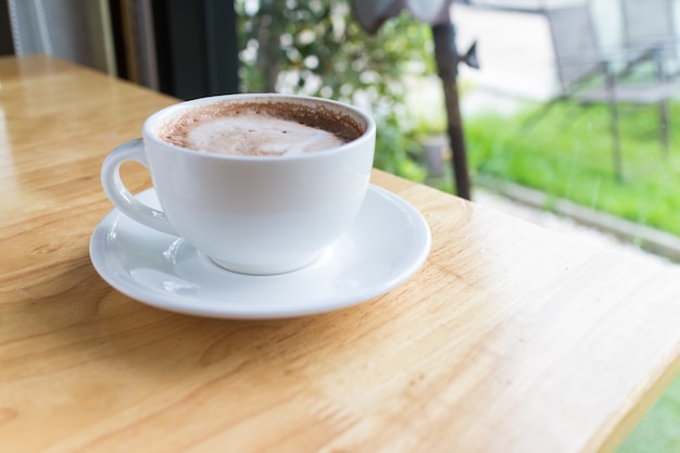 Hot coffee mocha with foam milk in countryside cafe