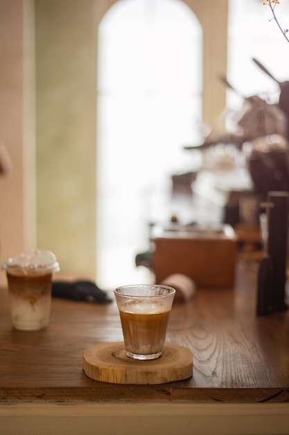 hot coffee on a table with cream being poured into it showing the texture