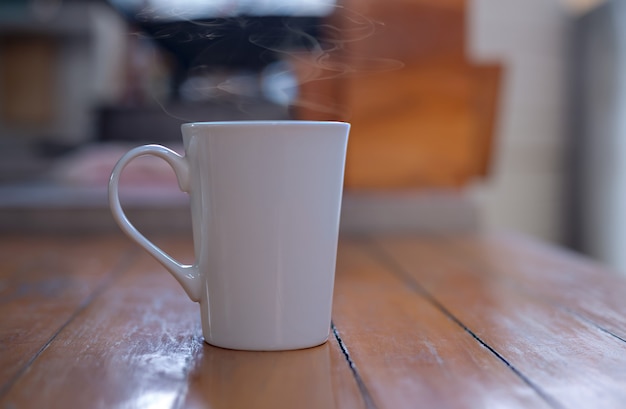 Hot coffee in a white cup on the table