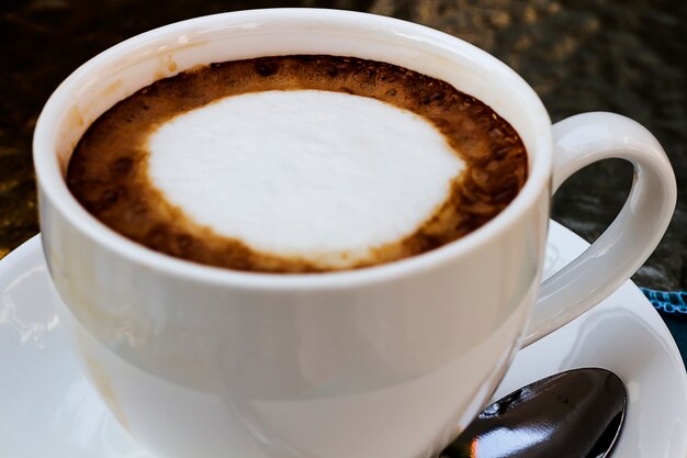 Hot coffee in a white cup