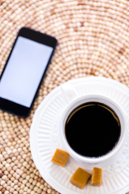 Hot coffee with caramel canies on the table.