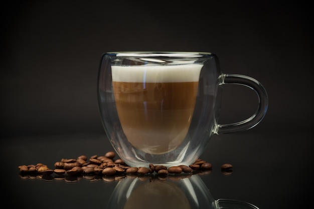 hot coffee with milk on black background