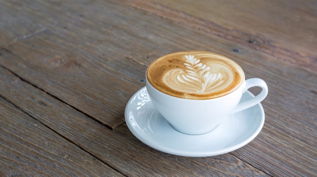 Hot coffee on a wooden table.