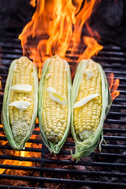 Hot corncob on grill with butter and salt