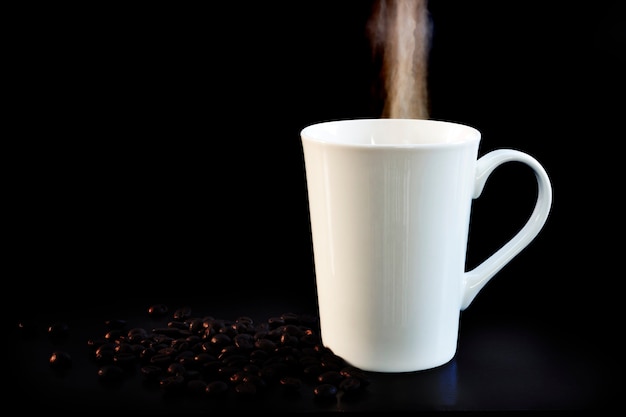 Hot cup of coffee in white on a dark background.