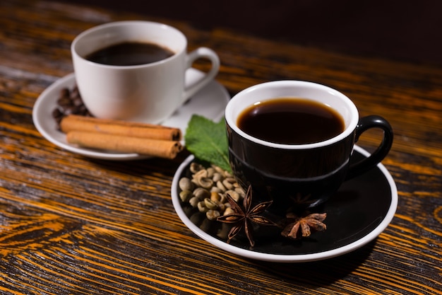 Hot cup of tea in focus with coffee behind it