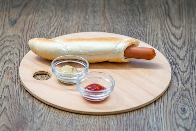 Hot dog in a roll with mustard and ketchup