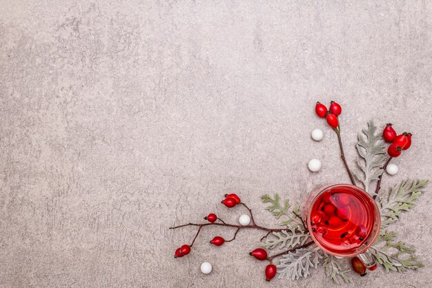 Hot dog-rose tea. Winter drink for good mood with fresh berries, leaves and candies. 