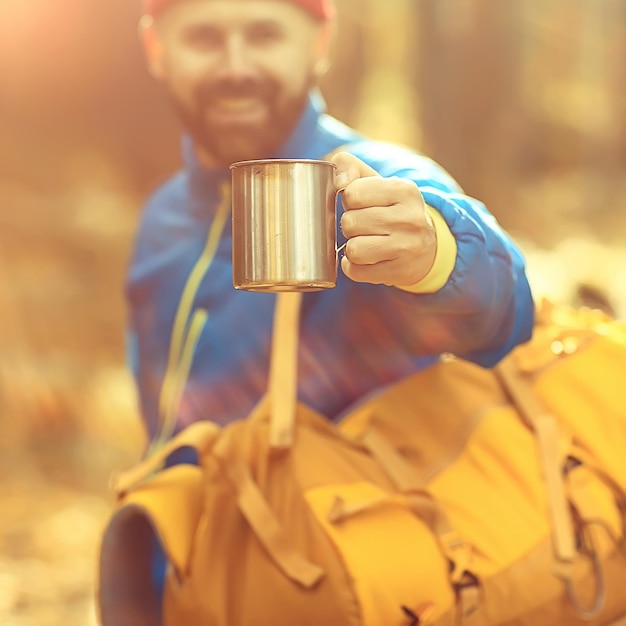 hot drink on the hike, a man drinks hot on the hike, adventure forest October