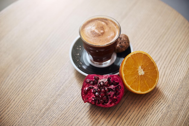 Hot drink with fresh fruit on table