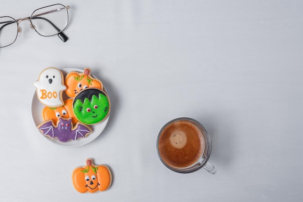 Hot espresso coffee or chocolate cup with funny Halloween Cookies Happy Halloween day Trick or Threat Hello October fall autumn Traditional party and holiday concept