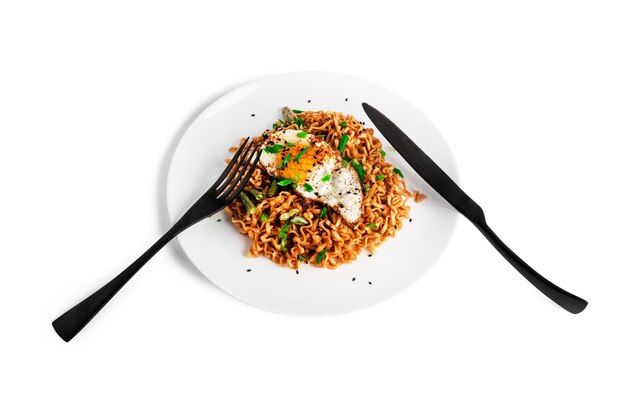 Hot fresh noodles with fried egg isolated on a white background. High quality photo