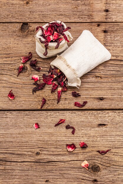 Hot hibiscus tea. Dry petals, linen sacks. Healthy food and self-care concept.