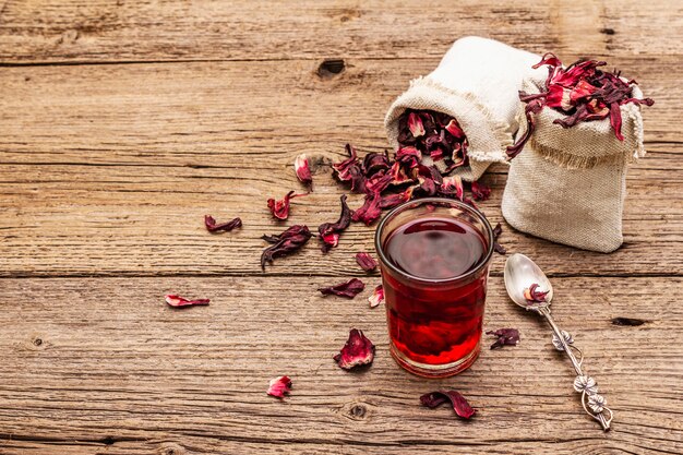 Hot hibiscus tea. Dry petals, linen sacks. Healthy food and self-care concept.