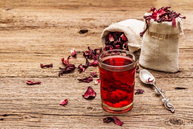 Hot hibiscus tea. Dry petals, linen sacks. Healthy food and self-care concept.