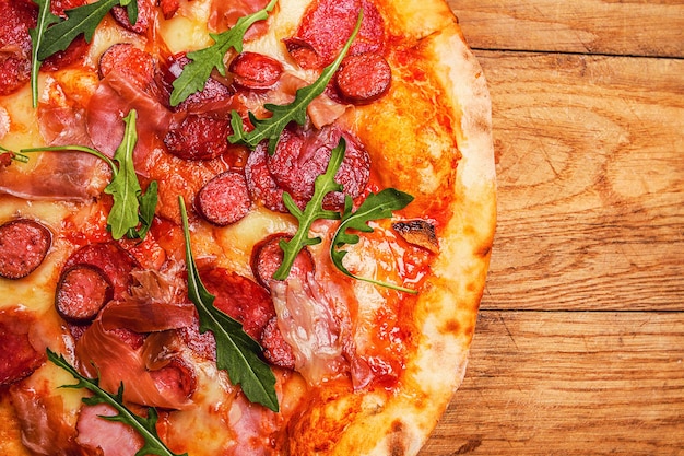 Hot pizza on a rustic wooden table