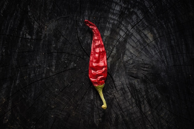 Hot red pepper on textured black desk