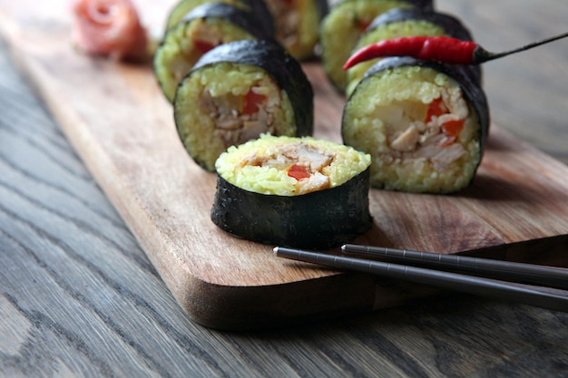 Hot roll set sashimi japanese food on wooden background with lemon and chopsticks