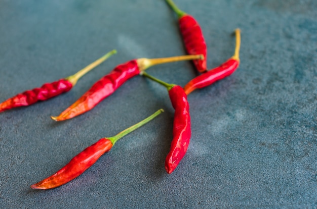 Hot and spicy chili pepper on dark background,