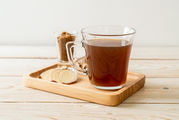 hot and sweet ginger juice glass with ginger roots - Healthy drink style