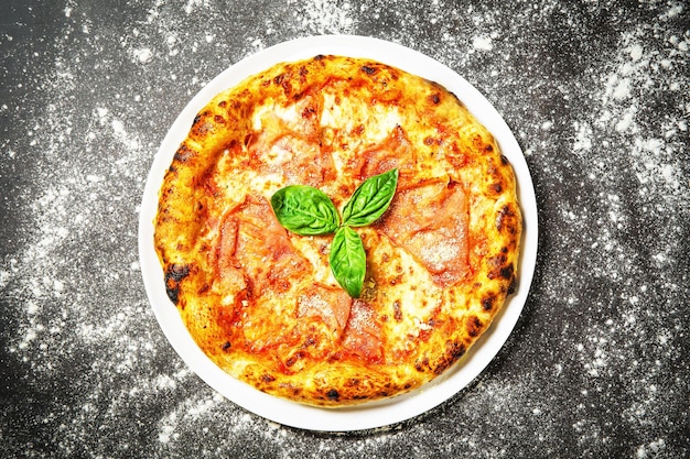 Hot tasty traditional italian pizza with ham