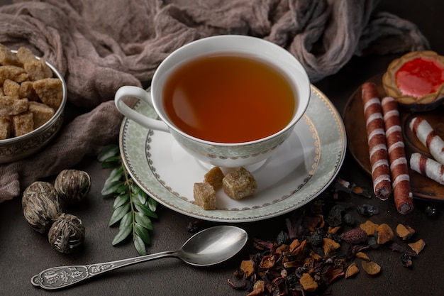 Hot tea in a cup on an old background