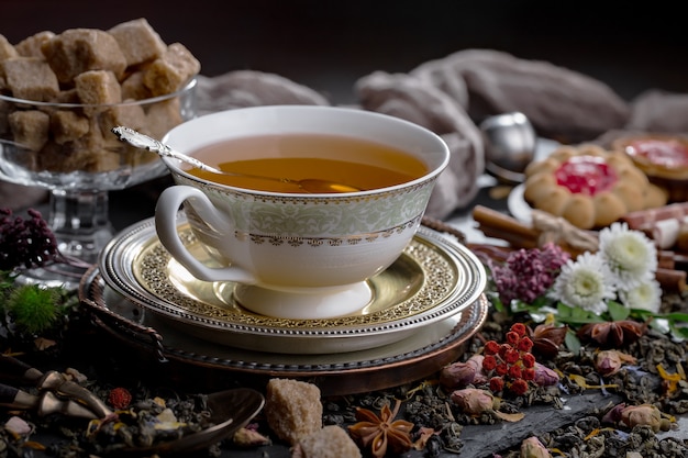 Hot tea in a cup on an old background