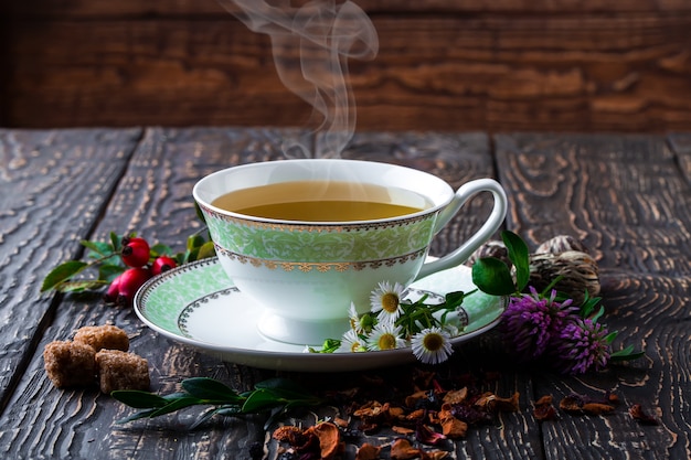 Hot tea in a cup on an old surface