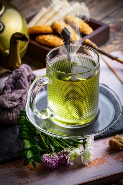 Hot tea in a cup on an old table.