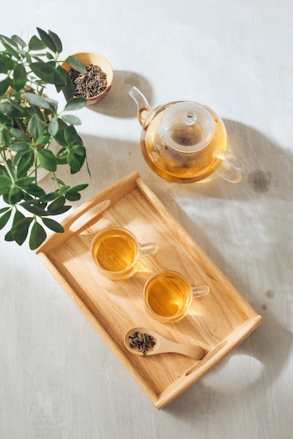 Hot tea is in the glass Placed on a wooden tray