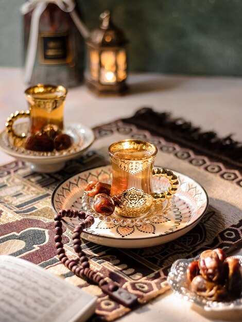 Hot Tea served with date fruits on the table. Middle East vibes