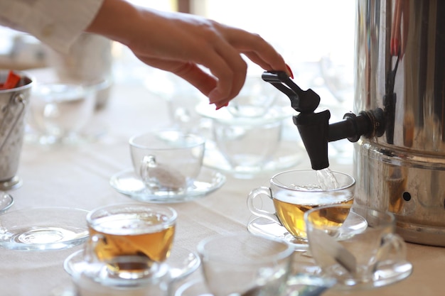 hot tea in a transparent glass mug at an event