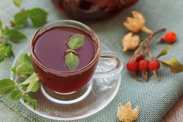 Hot tea with rose hips and herbs in a glass bowl Drink containing vitamin C and antioxidants