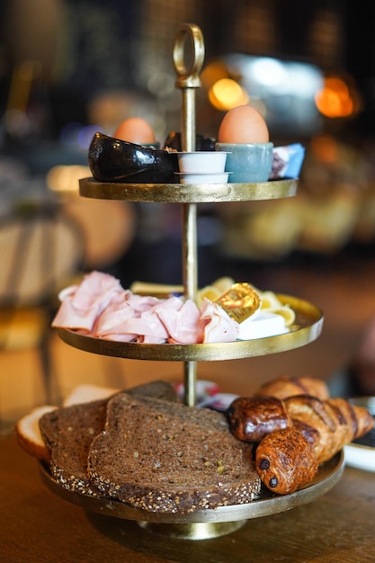 Hotel breakfast presented in a tower with three levels.