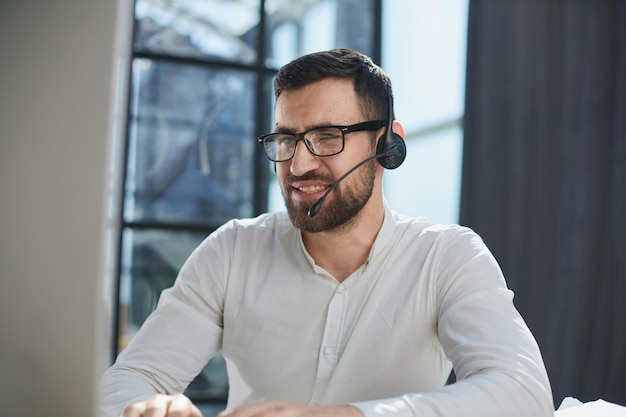 Hotline and helpdesk support operator working in office