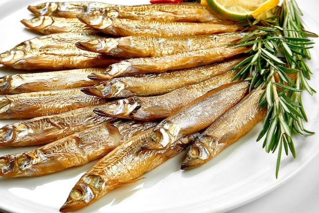 Hotsmoked fish in a plate on a white background Closeup Selective focus