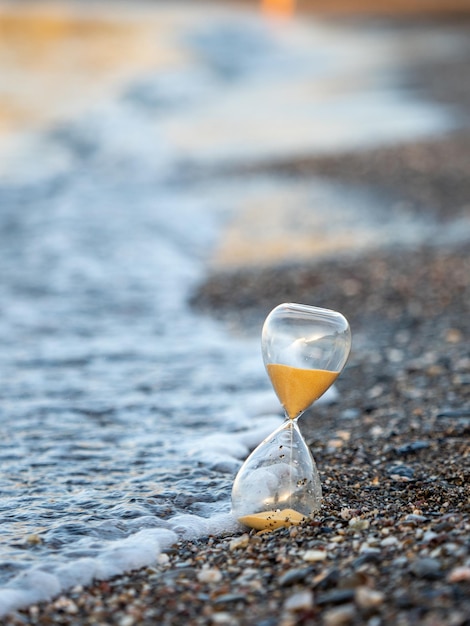 Hourglass on the beach at the seashore