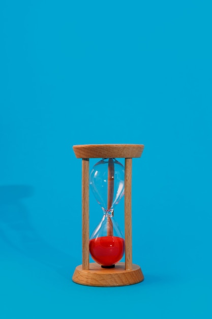 Hourglass on blue on blue background