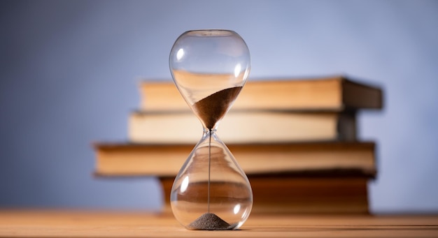 Hourglass and books