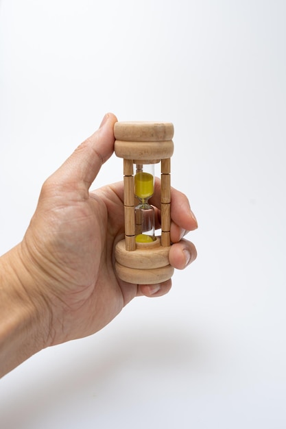 Hourglass held by an Asian on a white background