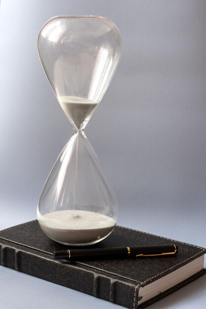 hourglass and notepad on blue background