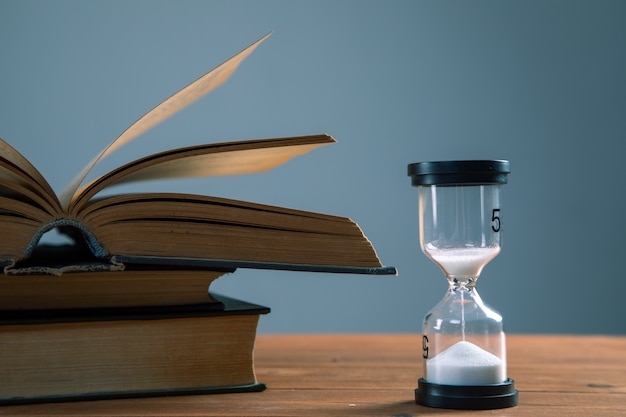 Hourglass with books on the table