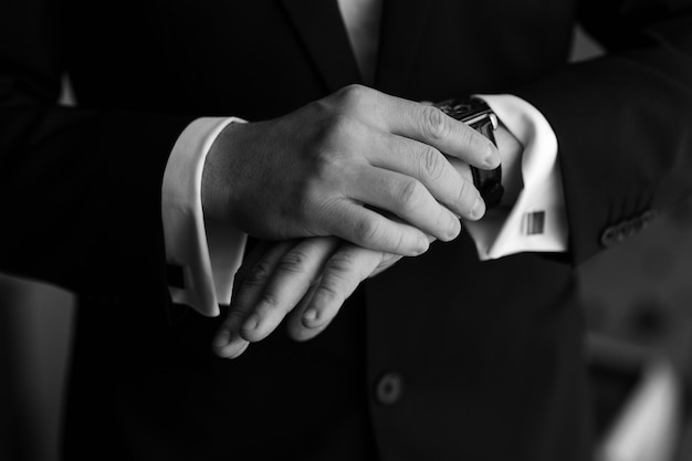 Hours on hands Businessman looking at his watch in office