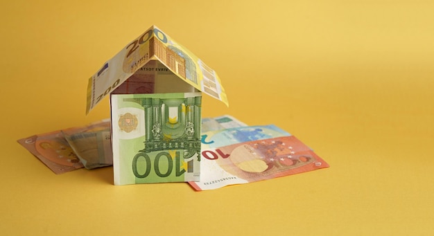 House built from banknotes House made from euro banknotes concept for real estate prices mortgages or home financing