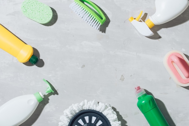 House cleaning products on wooden table. Salt pelets, baking soda (sodium bicarbonate), detergent, spray