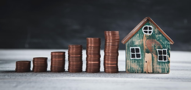 House and coins on the table