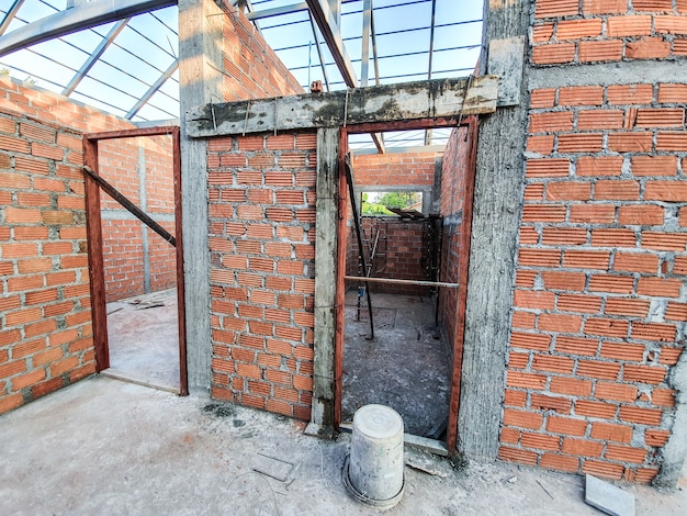 House construction site Use red bricks as a wall. With steel roof frame Concrete pillar.