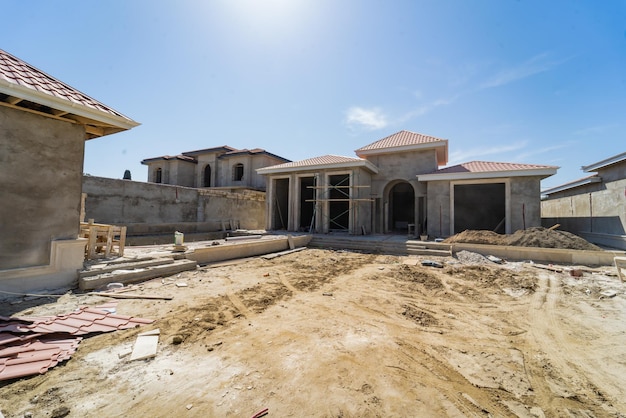 A house under construction with a blue sky in the background