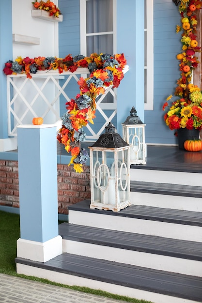 House entrance staircase decorated for autumn, with wooden lanterns