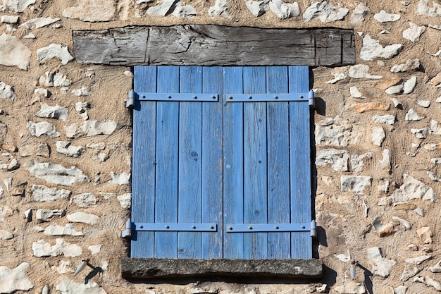 House facade with blue shutters in France